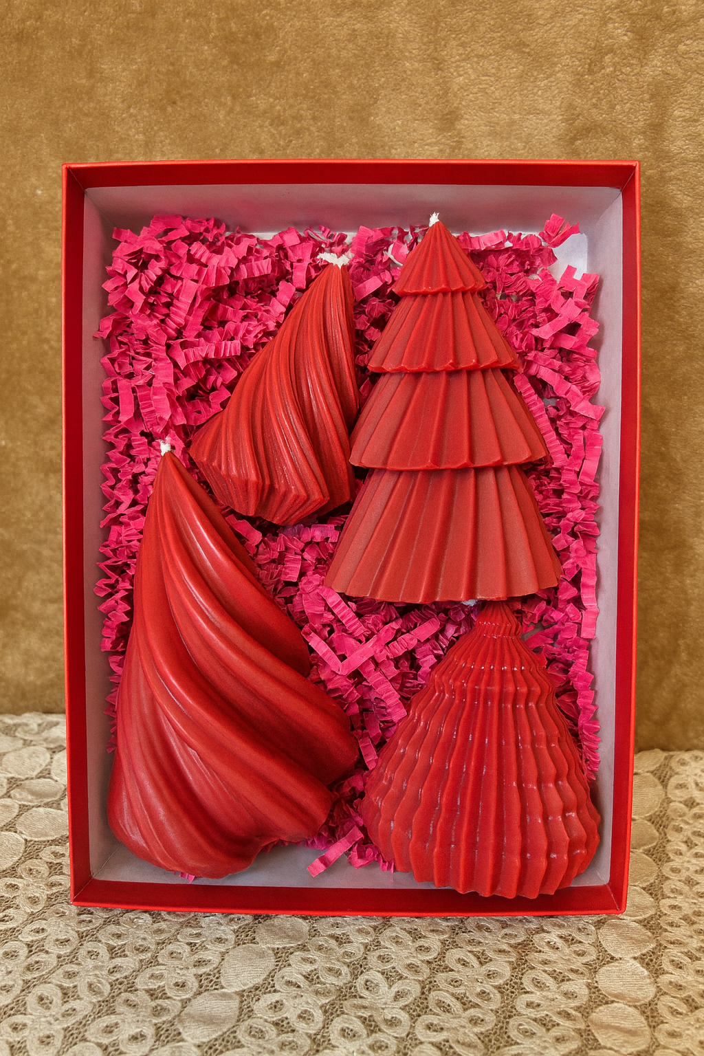 A bold and beautiful red Christmas tree candle collection designed for holiday décor and gifting.