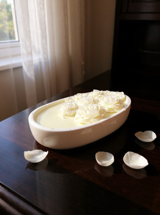 This luxury floral rose candle is a stunning piece of home decor, perfect for creating a relaxing atmosphere. Encased in a chic, oval ceramic dish, the candle features intricate, three-dimensional rose-shaped wax embeds (available in creamy white, vibrant pink, or deep burgundy) floating on a smooth pool of light-colored wax.