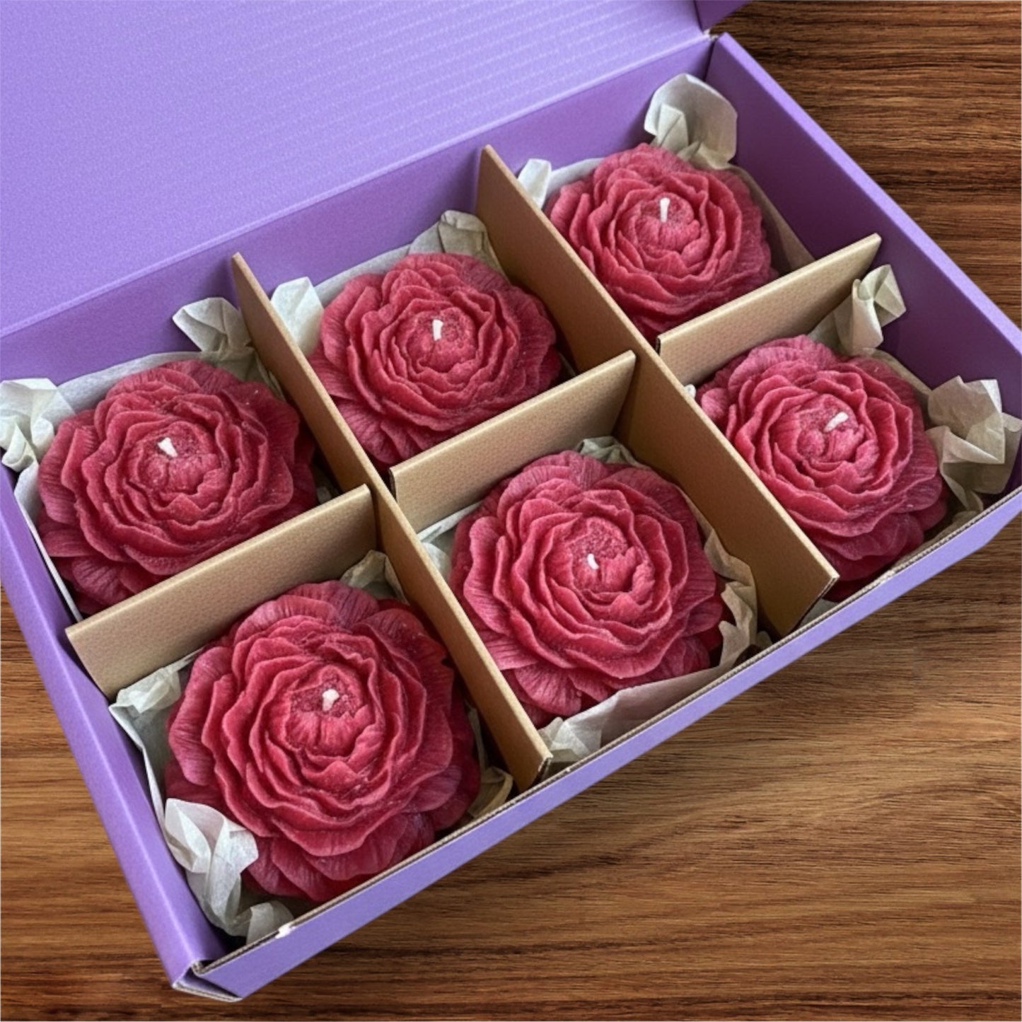 Six pack of red hand-carved floral rose candles in a purple gift box with dividers. Luxury romantic gift set.