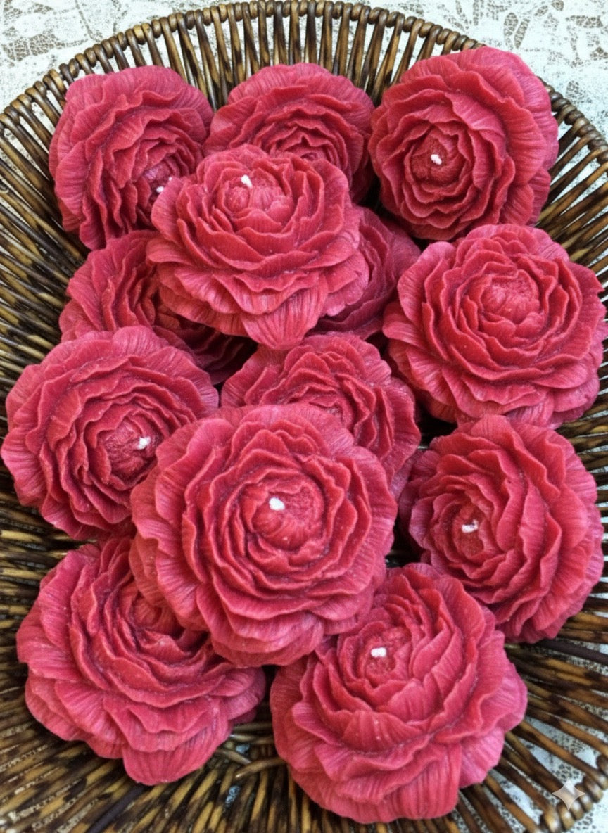 Close-up of hand-carved peony rose soy wax candles in a wicker basket. Rustic floral home decor.