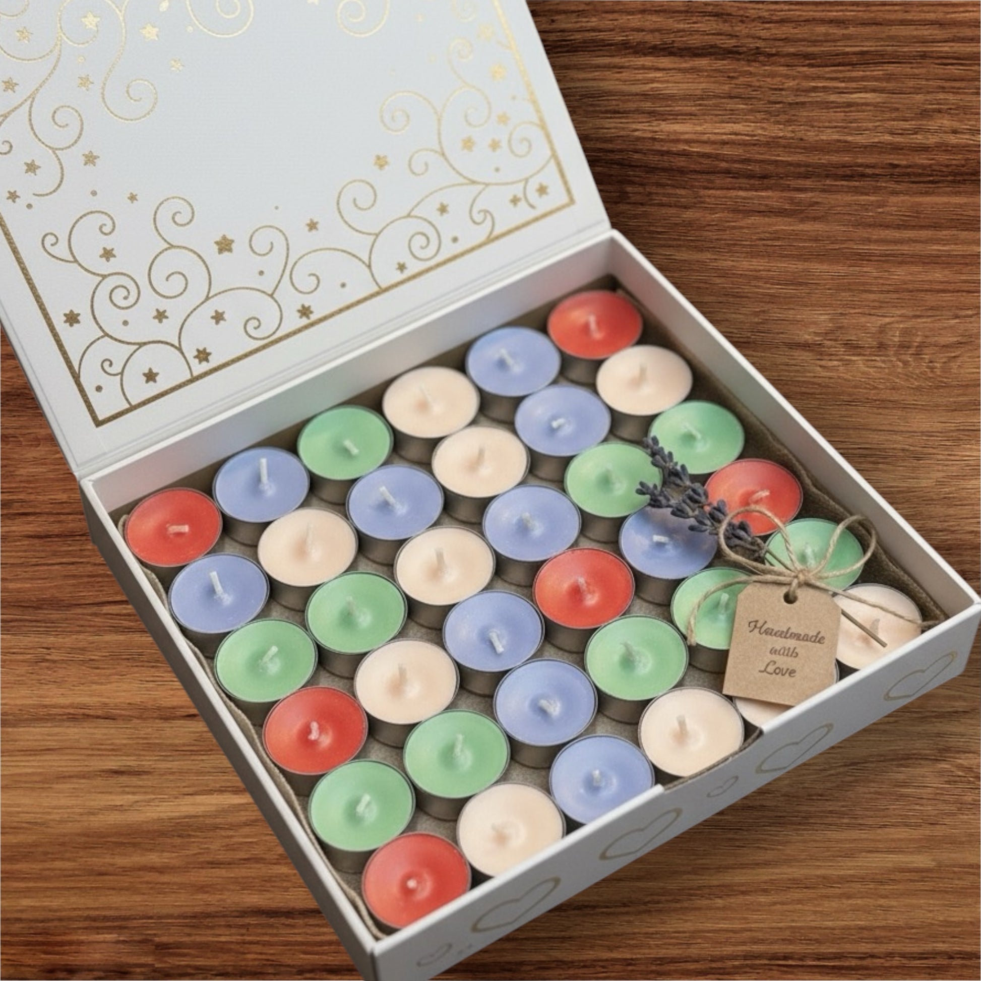 Box of colorful small candles with a lavender sprig on a wooden surface