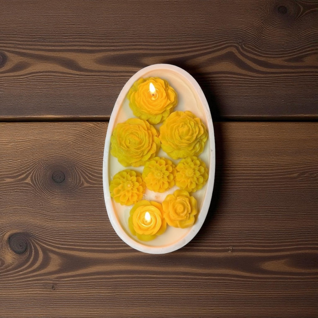 Decorative candle with floral designs on a wooden surface